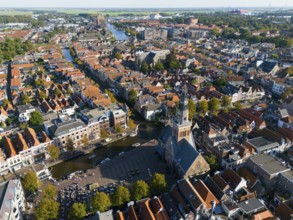 Expansive city view with a central church tower and neighbouring houses, aerial view, former city