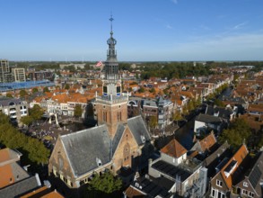 City view with a church tower surrounded by canals and red tiled roofs, aerial view, former city