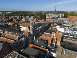 Aerial view of a city with historic buildings and a church under a clear sky, aerial view, town