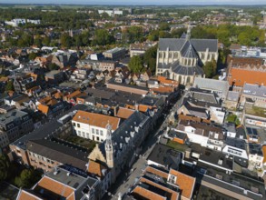 Panorama of the city with dominant church and surrounding historical buildings, under blue sky,