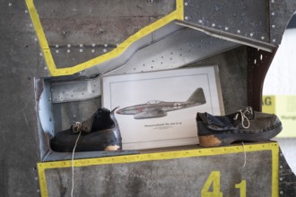 Wooden shoes of a forced labourer standing on an aircraft wing, documentation centre in the old