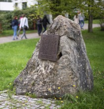 Stone with memorial plaque commemorating forced labourers and prisoners in concentration camp