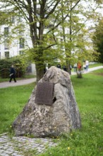 Stone with memorial plaque commemorating forced labourers and prisoners in concentration camp