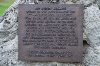 Stone with memorial plaque commemorating forced labourers and prisoners in concentration camp