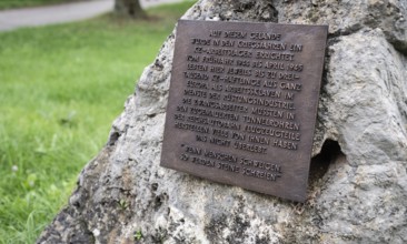Close-up, stone with memorial plaque to forced labourers in a concentration camp, station on the