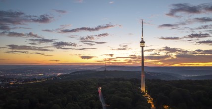 TV tower above wooded area at sunrise with dramatic sky, Stuttgart-Degerloch, Baden-Württemberg,