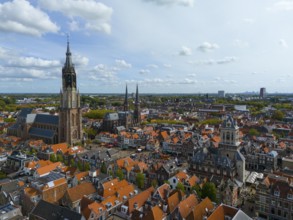 View of the city centre with several churches and red roofs on a cloudy day, aerial view, Nieuwe