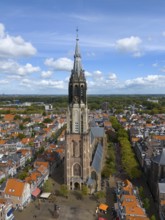 Aerial view of a church tower in the middle of a busy city with red roofs, Aerial view, Nieuwe