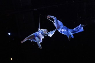 Two artists hover above the audience at the press screening of Alizé, a joint production by Cirque