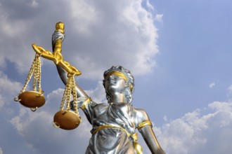 (Photomontage) Close-up of a Justitia in front of a blue sky