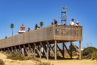 Tourists on the rocky coast of Ponta da Piedade, rugged coastal landscape, right next to Lagos city