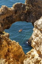 Excursion boats at the caves and rocky gates of the Ponta da Piedade rocky coast, rugged coastal