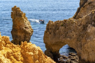 Excursion boats at the caves and rocky gates of the Ponta da Piedade rocky coast, rugged coastal