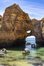 Excursion boats at the caves and rocky gates of the Ponta da Piedade rocky coast, rugged coastal