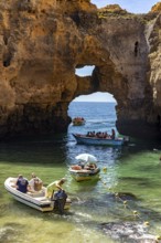 Excursion boats at the caves and rocky gates of the Ponta da Piedade rocky coast, rugged coastal