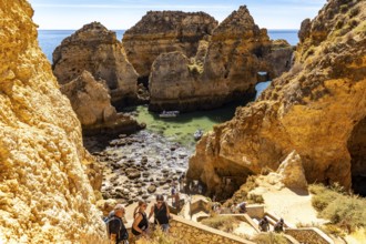 Excursion boats at the caves and rocky gates of the Ponta da Piedade rocky coast, rugged coastal