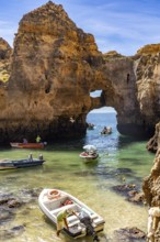 Excursion boats at the caves and rocky gates of the Ponta da Piedade rocky coast, rugged coastal