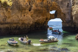 Excursion boats at the caves and rocky gates of the Ponta da Piedade rocky coast, rugged coastal