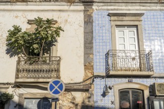 Facade of buildings decorated with tiles, azulejos, coloured tiles on facades, in Tavira, old town,