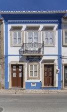 Facade of buildings decorated with tiles, azulejos, coloured tiles on facades, in Tavira, old town,