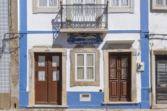 Facade of buildings decorated with tiles, azulejos, coloured tiles on facades, in Tavira, old town,