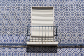 Facade of buildings decorated with tiles, azulejos, coloured tiles on facades, in Tavira, old town,