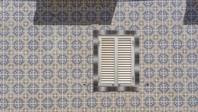 Facade of buildings decorated with tiles, azulejos, coloured tiles on facades, in Tavira, old town,