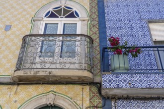 Facade of buildings decorated with tiles, azulejos, coloured tiles on facades, in Tavira, old town,