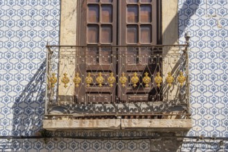 Facade of buildings decorated with tiles, azulejos, coloured tiles on facades, in Tavira, old town,