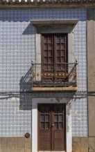 Facade of buildings decorated with tiles, azulejos, coloured tiles on facades, in Tavira, old town,