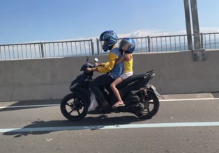 Father with child on motorbike, Cebu City, Cebu, Philippines