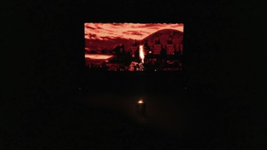 Dancers from Fire of Anatolia perform a choreography in red costumes with a historic stone wall