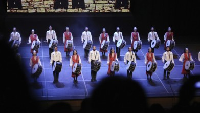 Dozens of members of Fire of Anatolia perform a drumming sequence during a cultural festival at