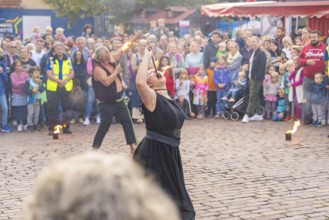 Street performance with fire breathers, surrounded by a curious crowd, Sindelfingen, Böblingen