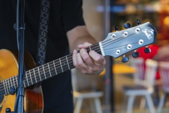 Close-up of a musician playing an acoustic guitar, Sindelfingen, Böblingen district, Germany