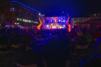 Concert stage illuminated at night with audience and atmospheric lighting effects, Sindelfingen,