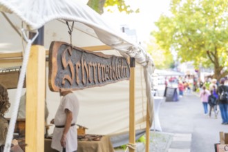 Sign above a market stall in a busy street, Sindelfingen, Böblingen district, Germany
