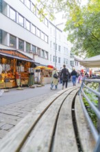 People stroll past stalls in a city with modern architecture, Sindelfingen, Böblingen district,