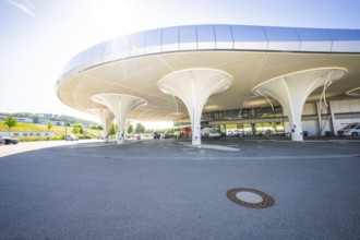 Modern, futuristic building with a curved roof in a sunny neighbourhood, Munich, Germany