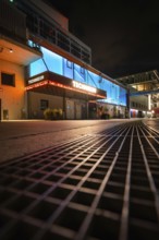 Night shot of an illuminated urban environment with modern buildings and architecture, Munich,