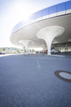 Curved, modern multi-storey car park structure with columns in daylight, Munich, Germany
