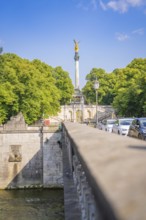 Urban view with bridge and traffic cars, surrounded by tall green trees and blue sky, Munich,