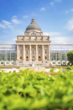 Large building with dome and columns, surrounded by plants, Munich, Germany