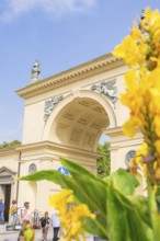 ArchiDecoration, historical architecture with yellow flowers in the foreground under a blue sky,