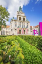 Impressive historic building with towers and a well-tended green space under a blue sky, Munich,