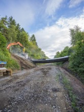 A wide path leads to a demolition site, excavator and fragments visible, bridge demolition, Calw,