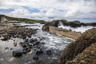 Breakwater at the fishing harbour, Ballintoy Harbour, Causeway Coastal Route, Antrim, Northern