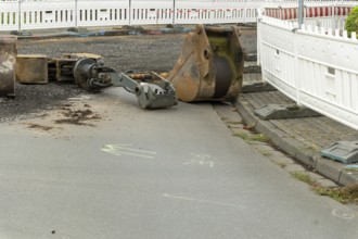 Borken, NRW, Germany, Excavator bucket and other equipment left on the ground at urban construction