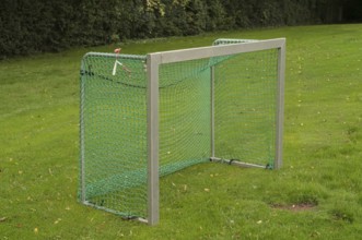 Borken, NRW, Germany, Soccer goal with green net standing on a grassy sports field