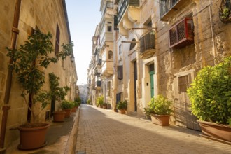 Street with wondeful historic houses with colorful wooden balconies in La Valletta, capital city of